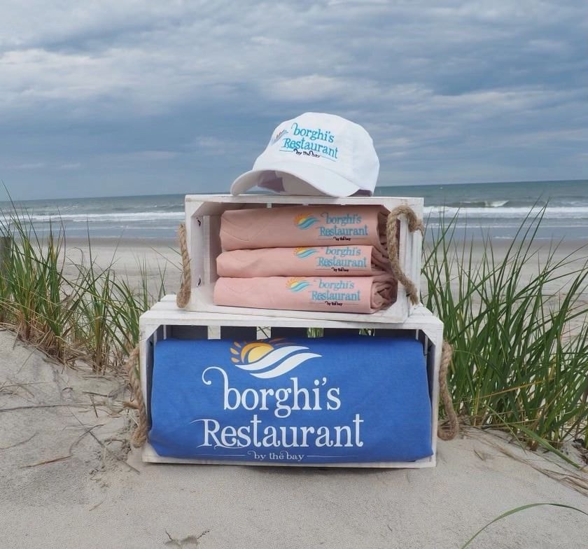Borghi's By The Bay branded merchandise on the beach